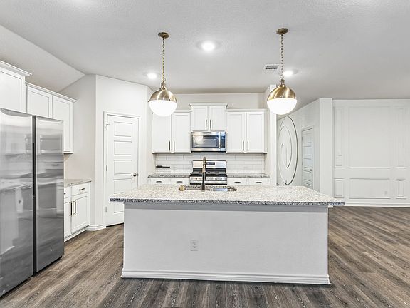 Look at those accent lights and the LED accent wall visible from the kitchen/living room area! This house is a VIBE!