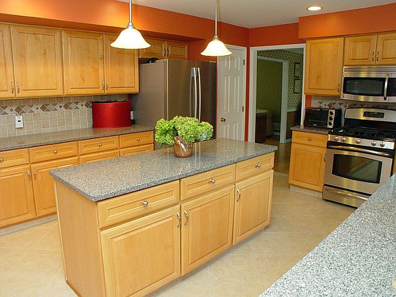 Updated kitchen with center island, granite counters, 42" cabinets, ceramic tile floor, GE profile oven/microwave