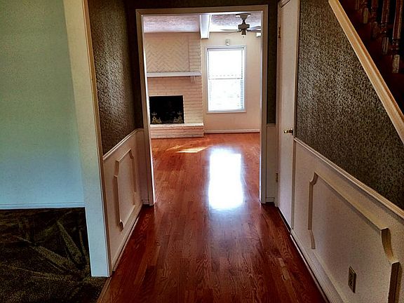 ENTRY LOOKS INTO LIVING ROOM AND FIREPLACE