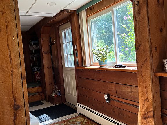 Main entrance and hallway off patio leading to large partially furnished livingroom.