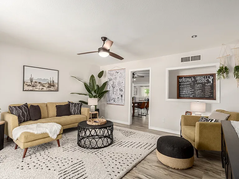 Large Smart TV and cozy seating overlooking the front yard & putting green