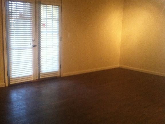 Spacious living room with wood floors and french doors.