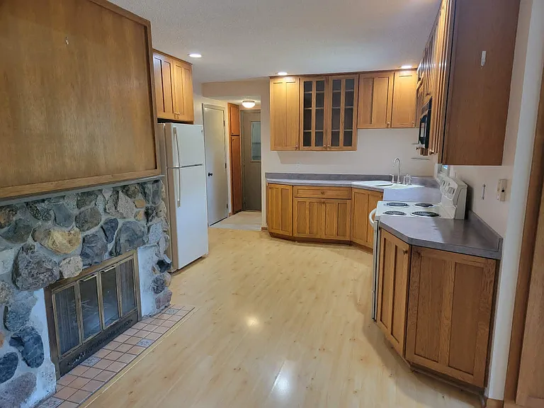 Kitchen includes dishwasher, fridge/freezer, electric range/oven and microwave. LOTS of cupboards and storage space. Fireplace for ambiance only (no fires allowed).