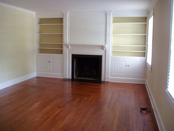 Formal living room with fireplaced flanked with built-in book cases