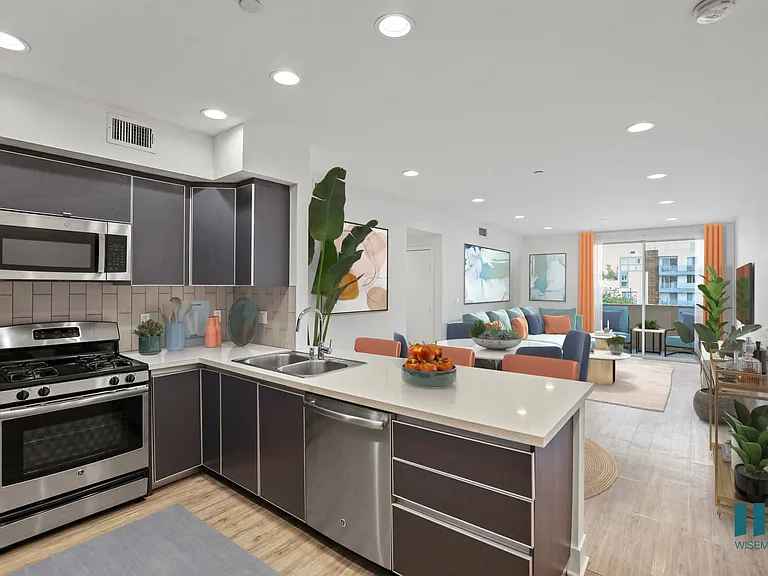 Open-Concept Kitchen, Dining, and Living Room with Patio