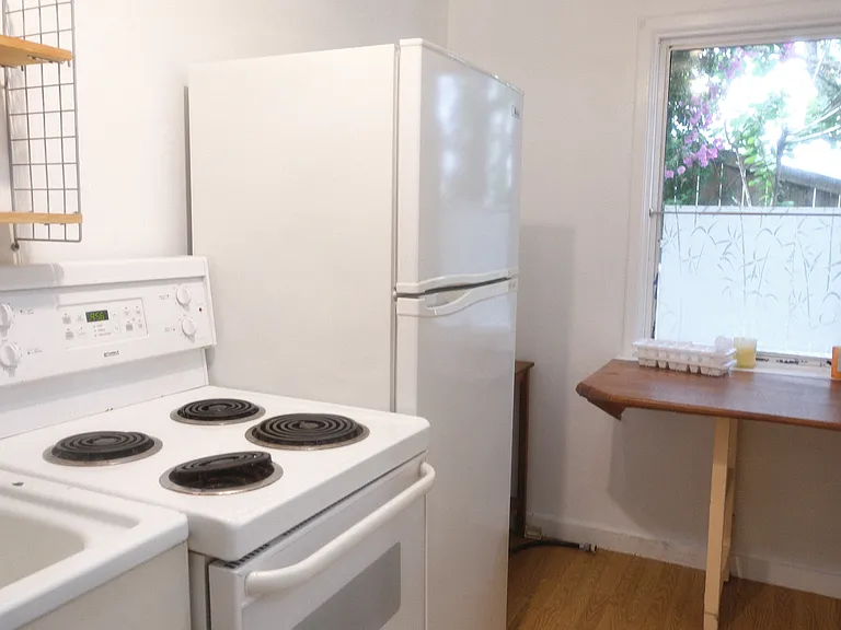 View of the kitchen - full fridge and full stove/oven range