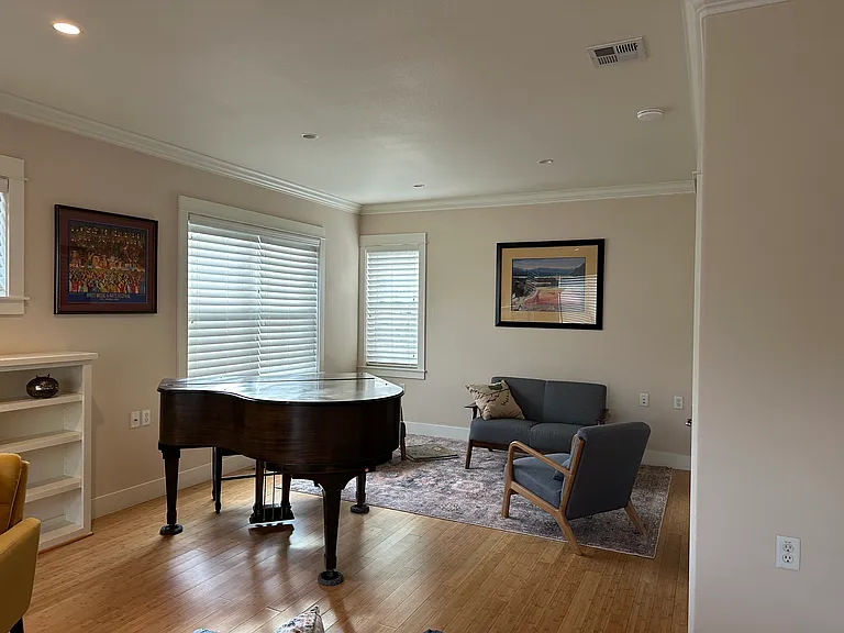 Baby grand piano in extra large living room
