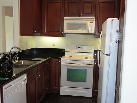Upgraded kitchen has granite counter tops and slate flooring