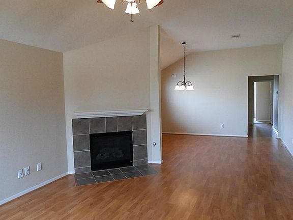 Living Room With Fireplace & Laminate Floors.