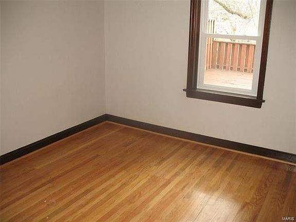 Bedroom #2 with side and back windows (overlooking the deck), as well as closet.