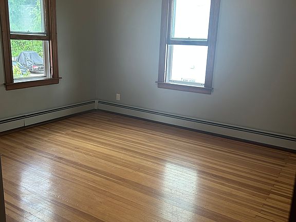Bedroom 1 with walk-in closet and hardwood floors