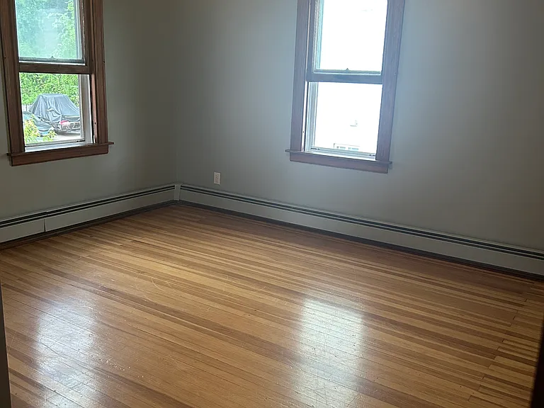 Bedroom 1 with walk-in closet and hardwood floors