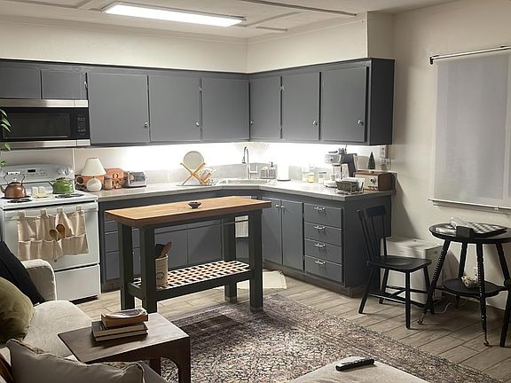 Living room; evening photo. Window opens unto deck and view