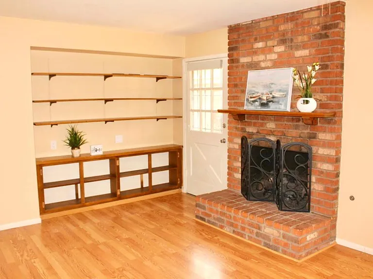 another view of living space front door and built in entry shelf