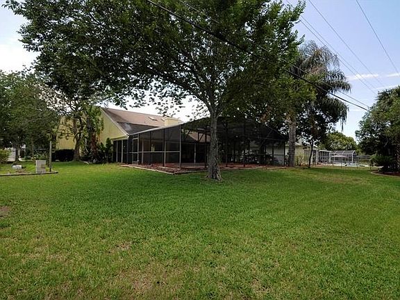 View of rear of home from backyard, garden area to left