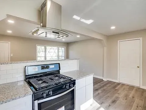 Kitchen with gas stove and high power vent hood
