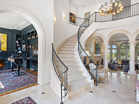 Upon entering the grand foyer, one is immediately greeted by a stately office on one side and a sophisticated formal dining area on the other. Exuding opulence and elegance, the central highlight of t