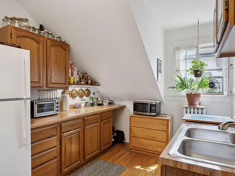 Full kitchen with natural light, two sinks, full appliances, and ample storage. Wired internet router in kitchen provides blazing fast fiber internet apartment-wide. Beautifully maintained hardwood floors throughout living space, bedroom, and kitchen.