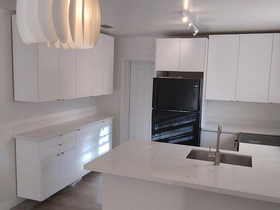 kitchen, with door in rear to rear bedroom with bathroom within this largest of the 3 bedrooms.