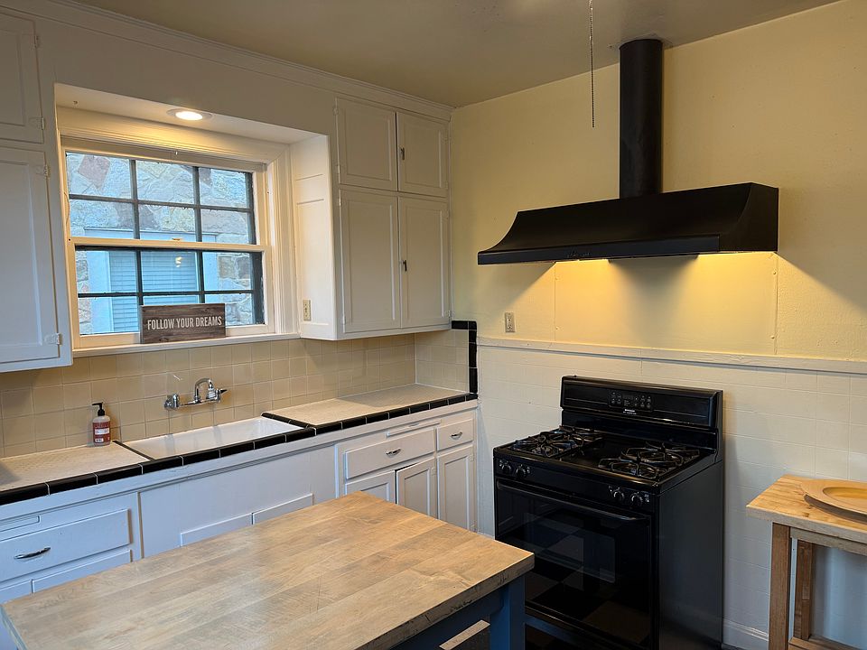 Kitchen is old school with gas stove and vent hood but no dishwasher or garbage disposal.