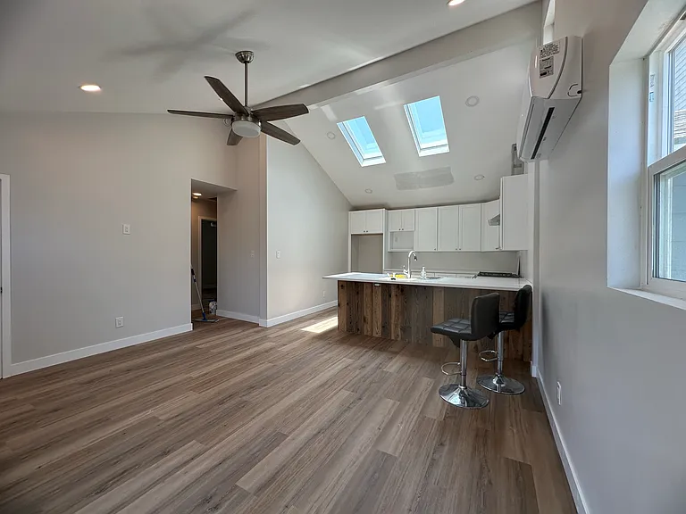 Open floorplan combines living room and kitchen into one spacious area. Sky light and vaulted ceilings provide natural daylight all day.