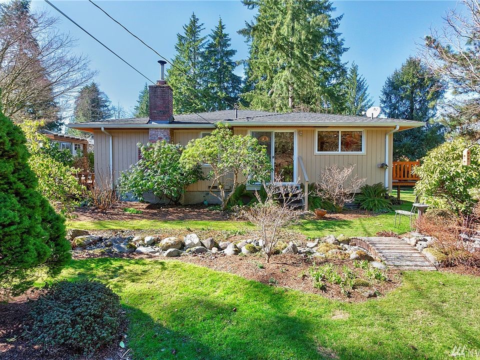 Darling home settled in an idyllic garden on 1.4 acres. 