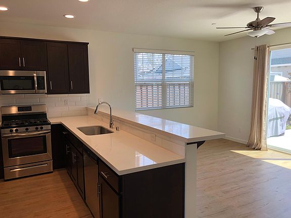 Kitchen and family area with sliding glass door to back patio