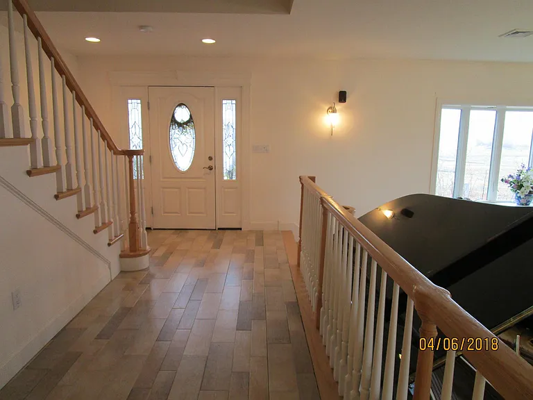 front entrance - stairs to sunken living room and main stairway to bedroom floor