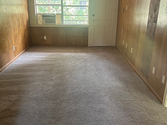 Living room and entrance with vintage mid-century wood paneling and ceiling