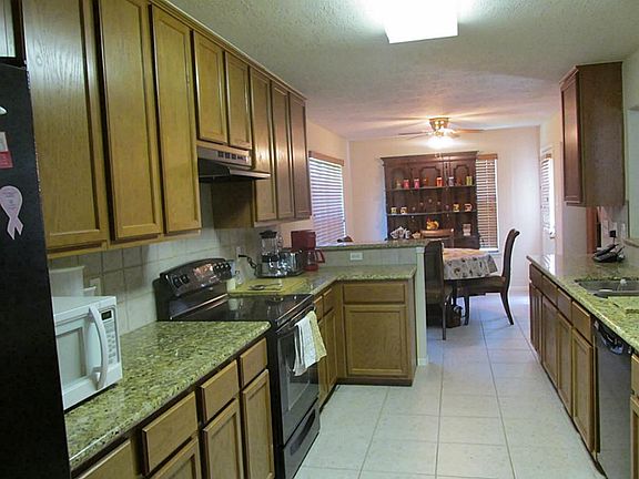  KITCHEN WITH GRANITE COUTNERTOPS, LARGE CABINETS, TILE FLOORING ELECTRIC RANGE