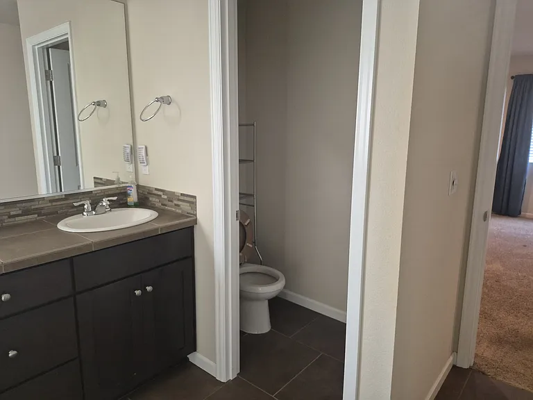 Master bathroom offers a toilet closet and double sinks.