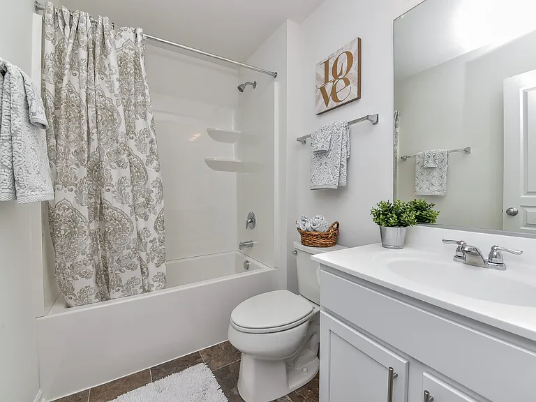 Secondary bedroom with attached en suite bathroom and walk in closet
