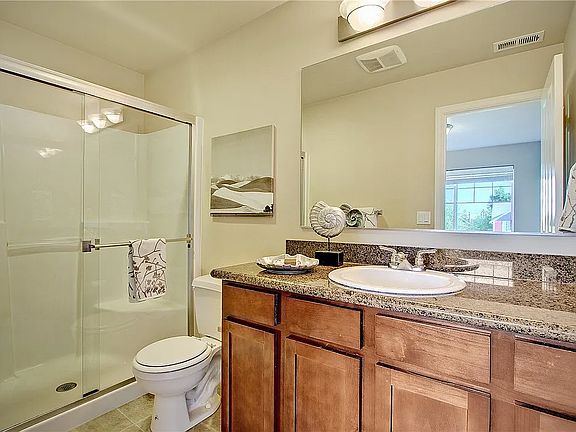 Attached master bathroom with standing shower.