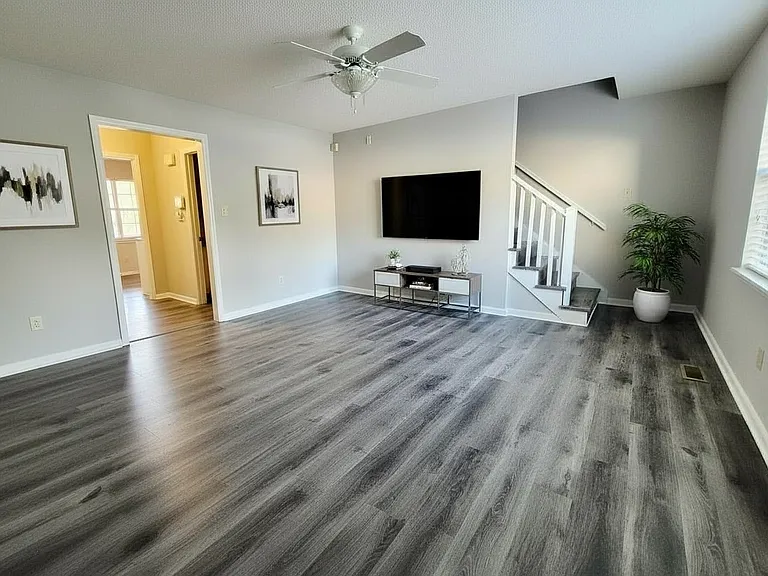 Spacious living room with plenty of natural light and a versatile layout.