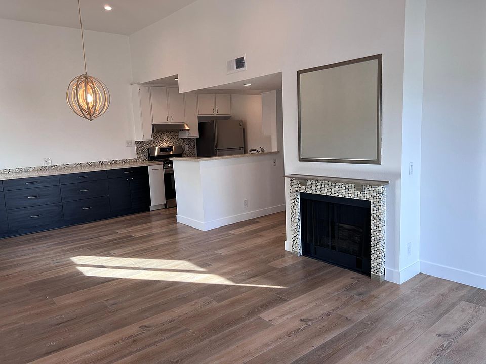 Vaulted ceiling in the great room with a charming fireplace and balcony.