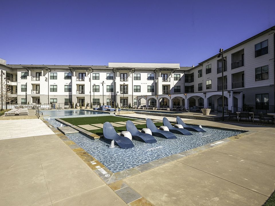 Experience ultimate relaxation with in-pool seating at Modera Walsh's expansive pool.