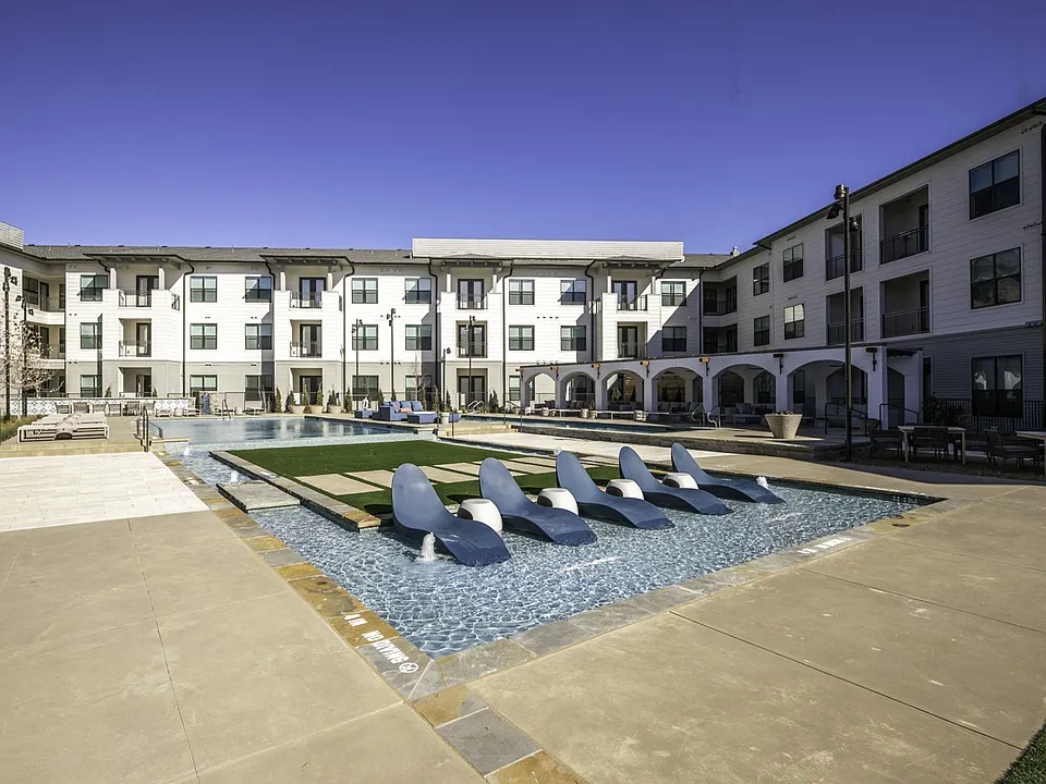 Experience ultimate relaxation with in-pool seating at Modera Walsh's expansive pool.