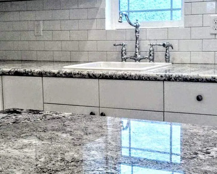 Crome sink fixture with window to look out to your completed fenced yard. High end Granite finishes.