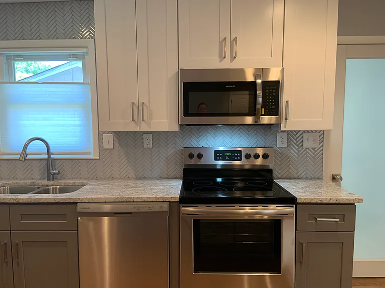 Under microwave lighting and beautiful backsplash tiling through the whole kitchen.