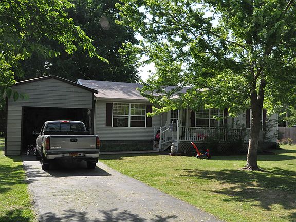 carport and a paved driveway