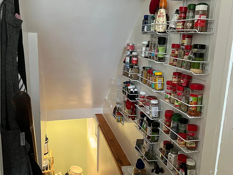 Lower Level Staircase off Kitchen with Organizing Shelves