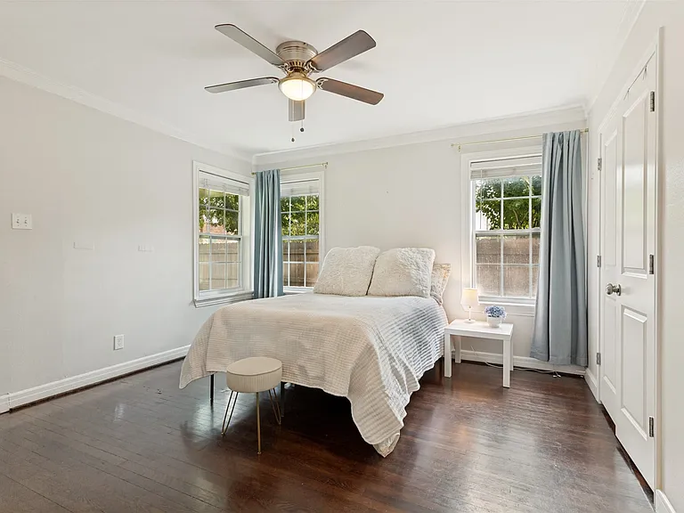 This bedroom has a large closet and a door to backyard porch.