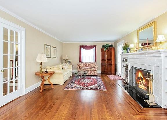 Large Living room with French doors from the center hall and wood burning fireplace