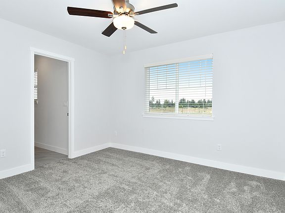 The master bedroom is spacious and has a large window.