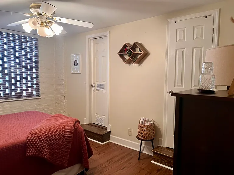 Bedroom Three has a walk in closet on the left, plus its own ensuite Full Bathroom on the right, and exposed brickwork.