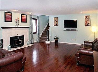 Family room is opn to kitchen & has oak floors & a log burning fireplace.