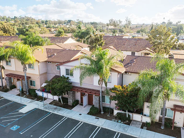 Arial view of parking lot and several units at The Nines Townhomes in Escondido, California.