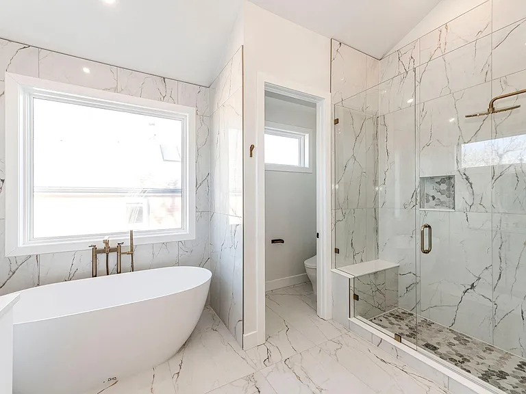 Primary bathroom suite. Large sinking tub with large tiled shower and double sinks.