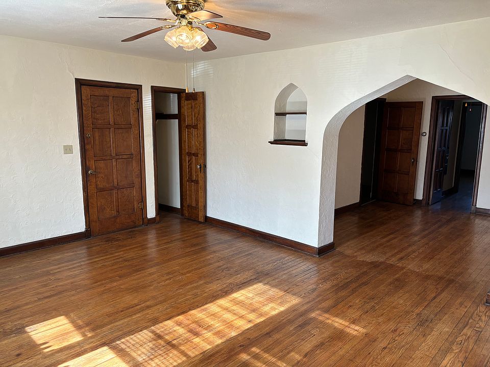 Living room with front door, coat closet and entrance to dining room.