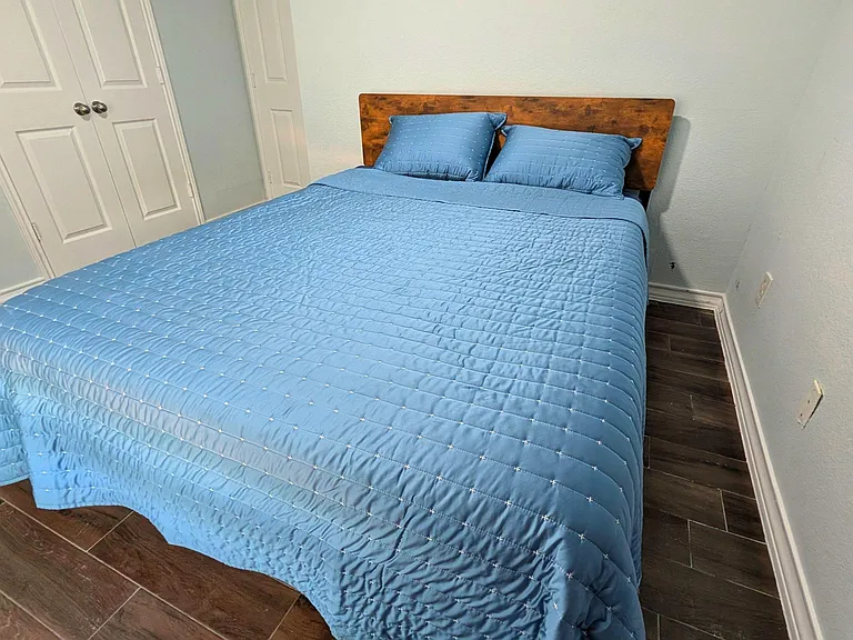 Private bedroom with a full bed, dual closets, and durable tile flooring for easy upkeep.